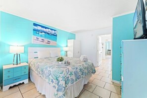 A bedroom with a bed, nightstands, a dresser, a painting, and a wardrobe. - Bluewater Resort 920-Oceanfront I/O Pool-Hot tub (Myrtle Beach)