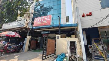 A hotel named 'XOTEL' with a sign indicating 'ms available.'