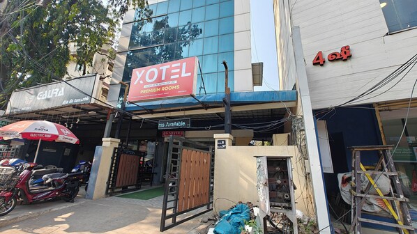 A hotel named 'XOTEL' with a sign indicating 'ms available.'