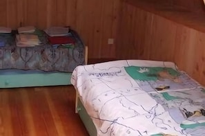 Two bunk beds with wooden walls and a plain floor. - Morvan Natural Park Gîte with Private Terrace, Garden, and Wi-Fi (Quarré-les-Tombes)