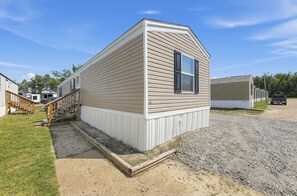 A single-story mobile home with a front porch and a gravel driveway. - 
Fully Furnished 3BR/2BA Monthly Workforce Housing Near Holly Ridge Data Center (Monroe)