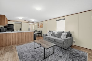 A modern living space with a kitchen, dining area, and seating area. - 
Fully Furnished 3BR/2BA Monthly Workforce Housing Near Holly Ridge Data Center (Monroe)