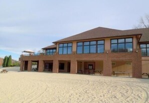 A two-story building with a brick facade and large windows. - Walk to Pool & Lake! 5BR Family Hideout Retreat With AC (Lake Ariel)