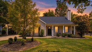 A single-story house with a front porch, a chimney, and a well-maintained lawn. - Cottontown Cottage | Fenced Yard & Covered Patio (Columbia)