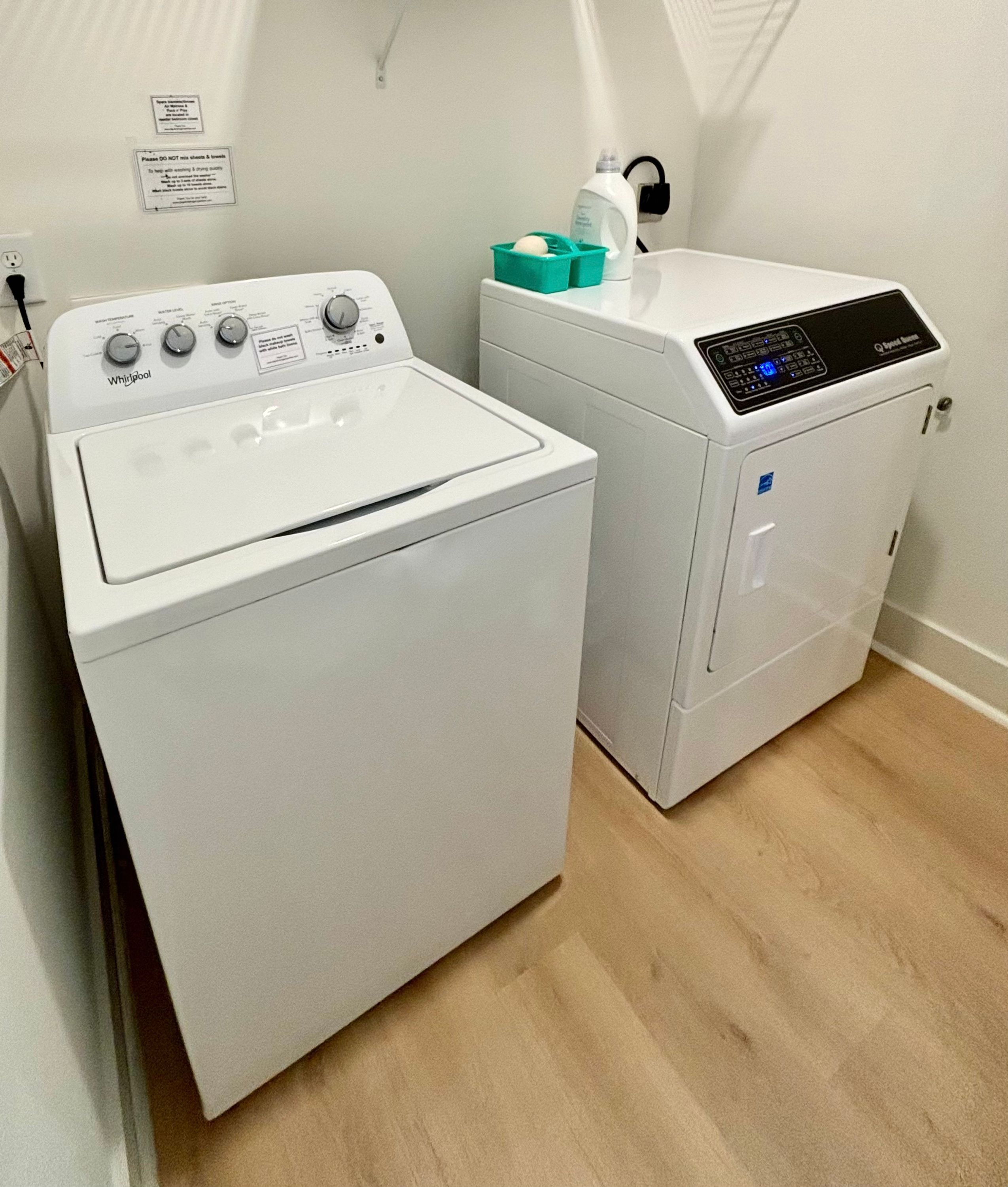 A laundry area with a Whirlpool washer and a front-loading dryer.