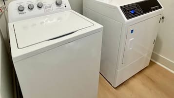 A laundry area with a Whirlpool washer and a front-loading dryer.