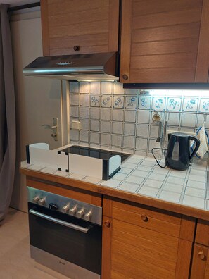 A kitchen with a Bosch oven, a built-in microwave, and a stainless steel range hood.