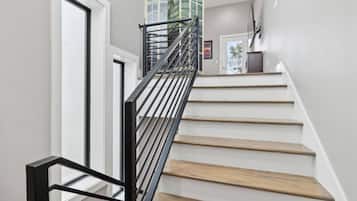 A staircase with wooden steps and a black metal railing.