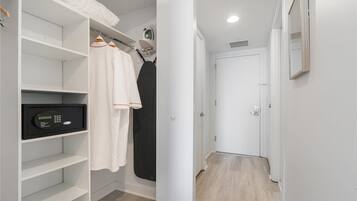 Un vestidor con estantes, una barra para colgar y una cerradura digital.