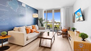 A modern living room with a large map on the wall, a sofa, a coffee table, and a view of the city through large windows. - Modern Resort -balcony Views Pool (Hallandale Beach)