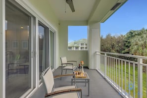 A balcony with two chairs, a table, and a bottle of wine. - Stylish Apartment 1BR - 2bth (Miami)