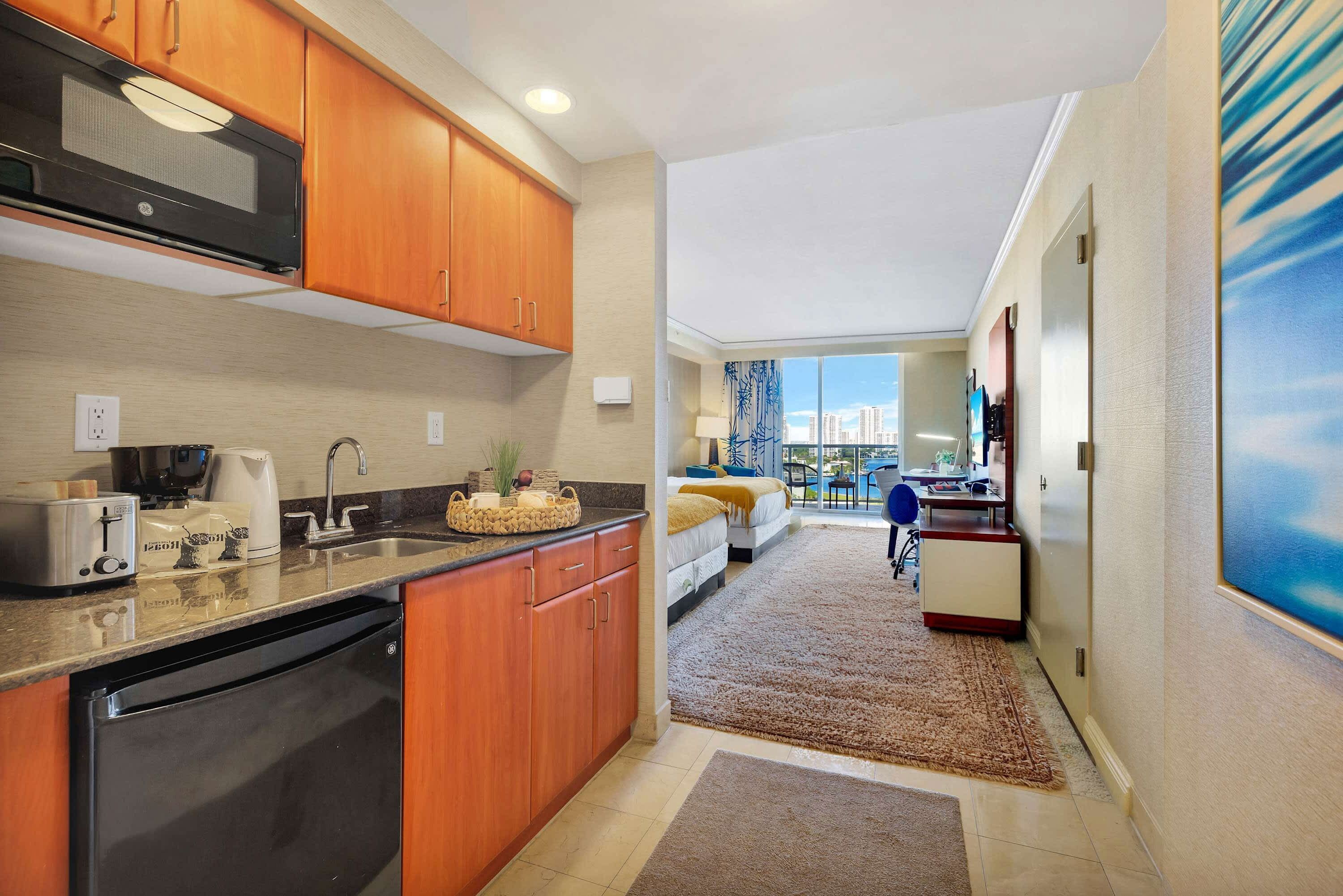 A modern kitchen with wooden cabinets, a microwave, and a dishwasher.