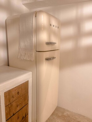 A white refrigerator with the brand name 'SMEG' on the top. - Soumaki Countryside Villa (Pano Akourdalia)