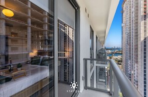 A high-rise building with a balcony overlooking a marina and cityscape. - Sophisticated Studio w Pools (Miami)
