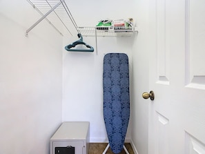 A small room with a white door, a white cabinet, and a wall-mounted drying rack with clothes. - Golfview Pool Home Southern Dunes (Haines City)