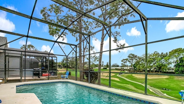 Una piscina con vista a un campo de golf.