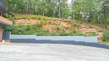 A building with a concrete patio and a retaining wall.