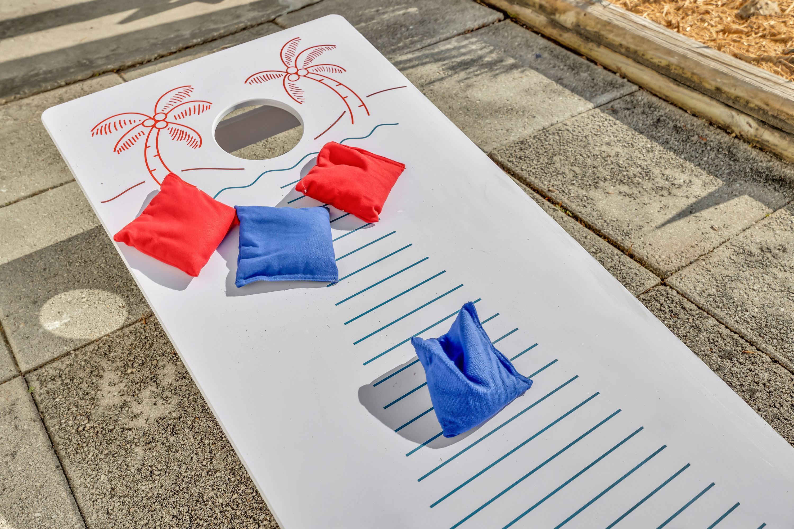 A white board with lines and a hole in the center, possibly for a game or activity.