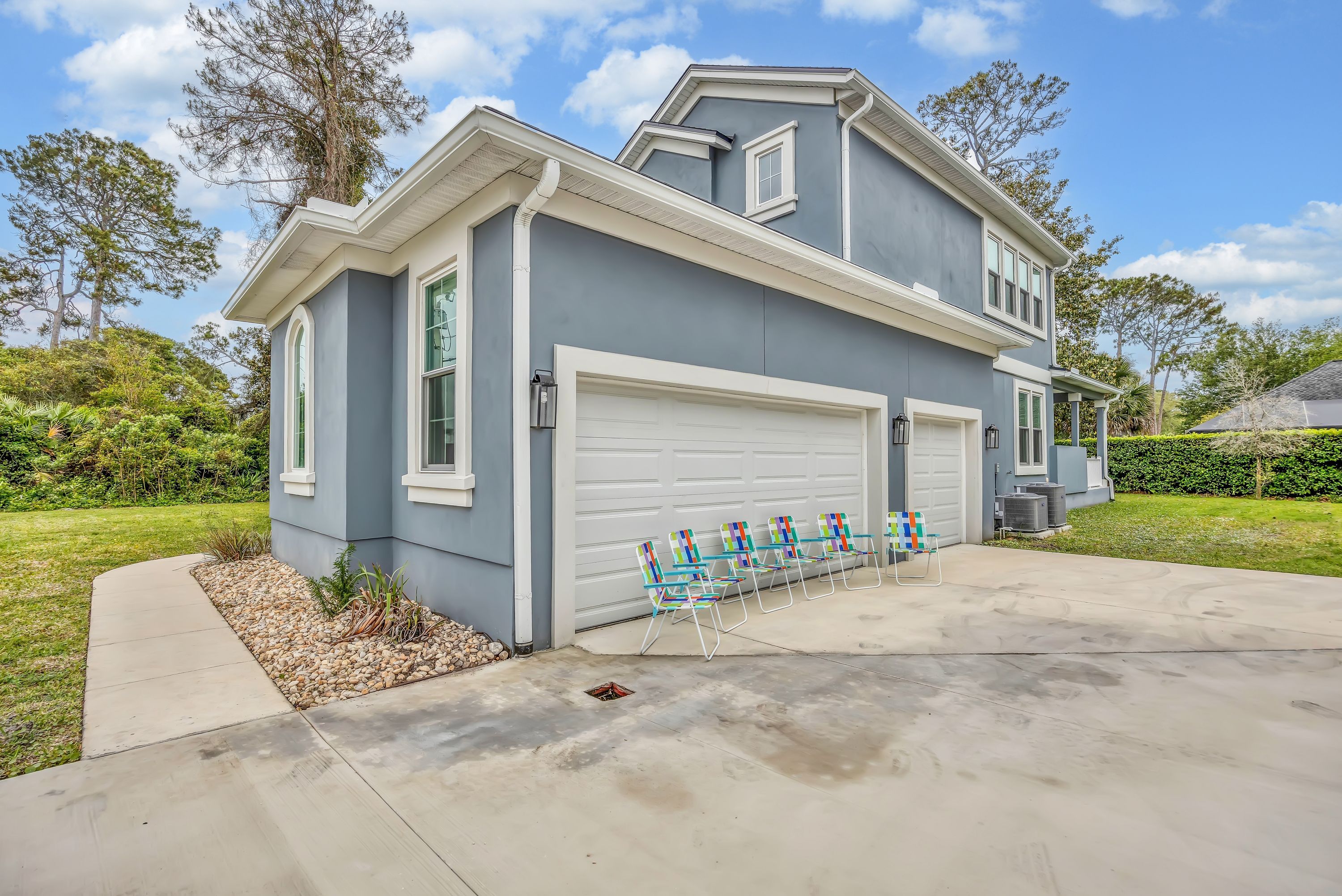 A two-story house with a garage and a driveway.