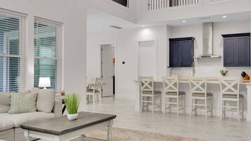 A modern interior with a dining area, kitchen, and living space.