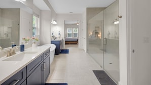 A modern bathroom with a walk-in shower, a large mirror, and a vanity with a sink. - Salt Air 6BR Game Room Walk to Beach Luxe (Ponte Vedra Beach)