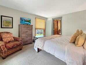 A bedroom with a bed, a desk, a chair, a dresser, and a window with blinds. - New Listing - Plaza 339 — Updated 3BR Base Area Condo (Crested Butte)