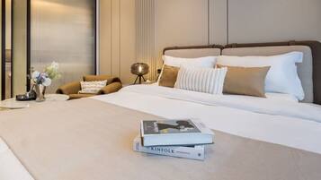 A hotel room with a large bed, a bedside table with a lamp, and a chair.