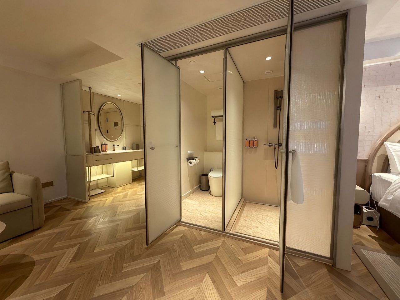 A modern bedroom with a large bed, a bedside table, and a wardrobe with a mirror.