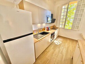 Eine moderne Küche mit Kühlschrank, Spüle und Mikrowelle.