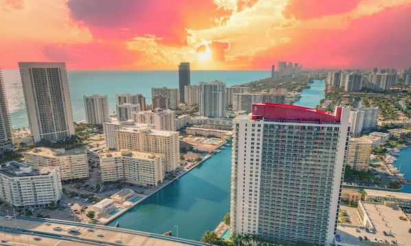 A high-rise hotel with a marina and a city skyline in the background. - 2BR BW Resort - Bay View Fitness Center (Hallandale Beach)