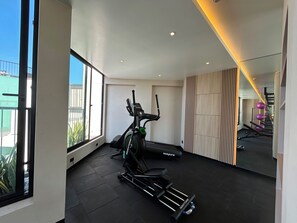 A modern home gym with a stationary bike, treadmill, and weights. - Ocean-View Pool Just Steps from the Malecón | Apartment for 6 in Miraflores (Miraflores)