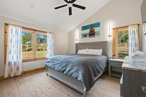 A bedroom with a bed, a nightstand, a ceiling fan, and a window with curtains. - New Pet Friendly Home w HotTub, FirePit, PoolTable (McHenry)