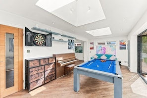 A modern living room with a pool table, dartboard, and a piano. - Ashcombe House • Sleeps 9 • Pool Table • Snug Room • SkyTV • Xbox • Driveway Parking • Yoko Property (Worthing)