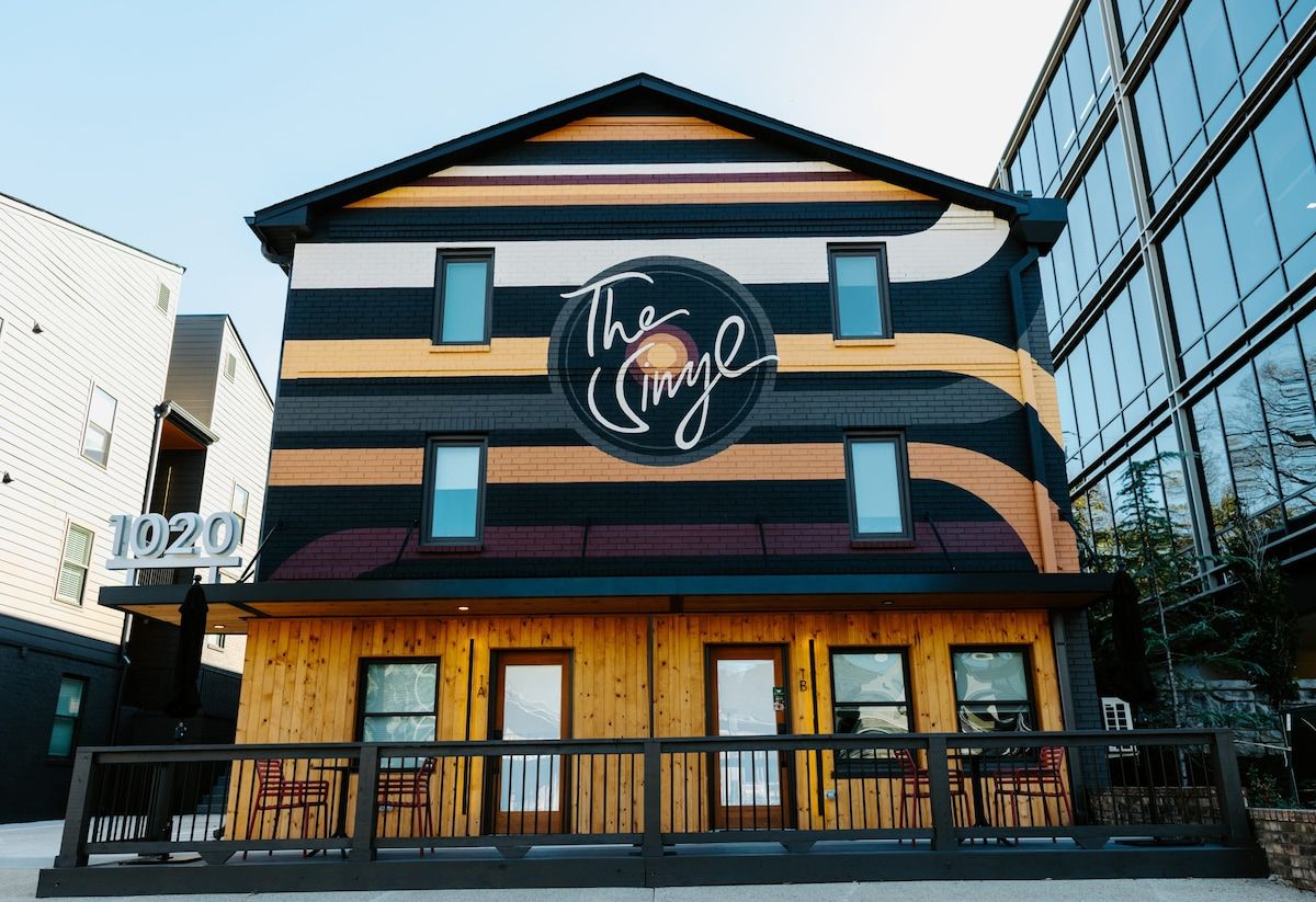 A building with a distinctive striped facade and a prominent logo.