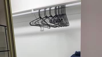 A closet with shelves holding towels and toilet paper.