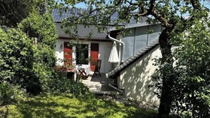 A residential property with a visible front yard, a staircase leading to the entrance, and a building with a sloped roof. - Hex"nhausla in Aufsess (Aufsess)