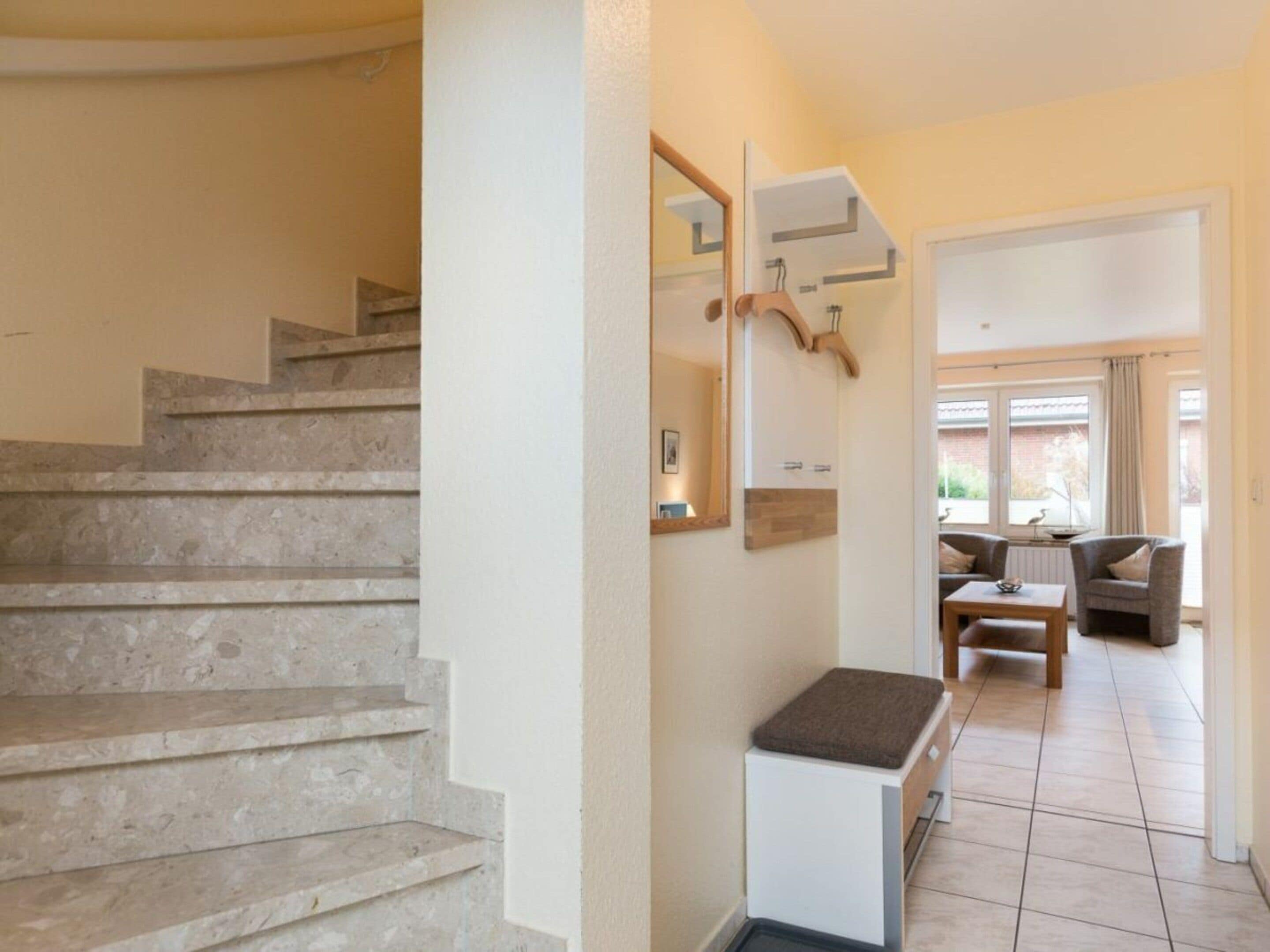 A staircase leading to a living area with a sofa and a table.