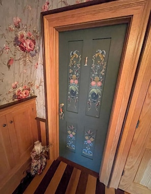 A wooden door with floral designs and a number '1' on it.