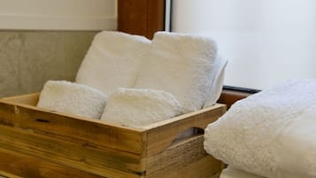 Una caja de madera con varias toallas blancas.