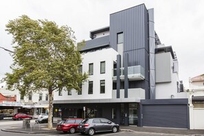 A modern building with a flat facade, large windows, and a garage door. - BOWIE Sun soaked Comfort in the Heart of Richmond (Richmond)