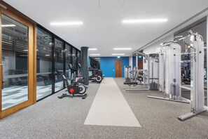 A gym with cardio machines, weightlifting equipment, and a clear path for walking. - Lakeside Lookout Modern Living with Majestic Views (Melbourne)