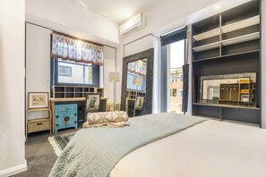A bedroom with a bed, a dresser, a wardrobe, and a window with curtains. - Hikari Haven Richmonds Creative Spirit near Cafs (Richmond)