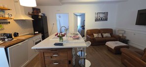 A compact living space with a kitchenette, a dining area, and a seating area with a sofa and armchairs. - Old Square Senj apartment: the authentic atmosphere of the old coastal town. (Senj)