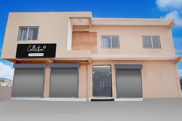 A building with a sign that reads 'Collection Company Serviced'.