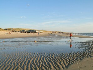 A beach with a sandy shore, a pier, and a clear sky. - Holiday Home With 2 Bedrooms (Sint Maartensvlotbrug)