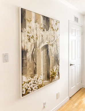 A large wall-mounted artwork depicting white flowers and a window. - Waterfront ski retreat on Blue Mountain. Pet-Friendly! (Collingwood)