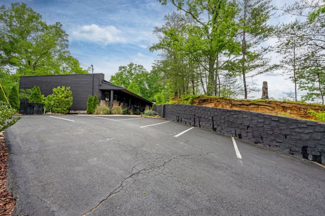 A parking lot with a building in the background.