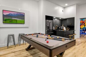 A modern kitchen with a built-in refrigerator and a bar area.