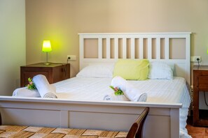 A neatly made bed with white linens and pillows, a bedside lamp, and a wooden nightstand. - Finca with pool Son Crestes, Sa Pobla (Sa Pobla)