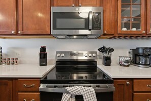 A kitchen with a stainless steel microwave, oven, and coffee maker. - Penny Lane Retreat | 15 Min. to Stadium (Columbia)